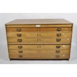 A mid century oak plan chest, in two sections, the size drawers with brass library pulls, 90cm high,