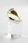 A yellow metal single stone ring. Set with an old European cut diamond