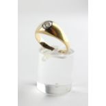 A yellow metal single stone ring. Set with an old European cut diamond