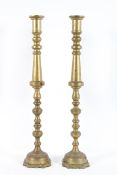 A large pair of brass candlesticks, each with knopped stems, on domed foot, with fixed sconce,
