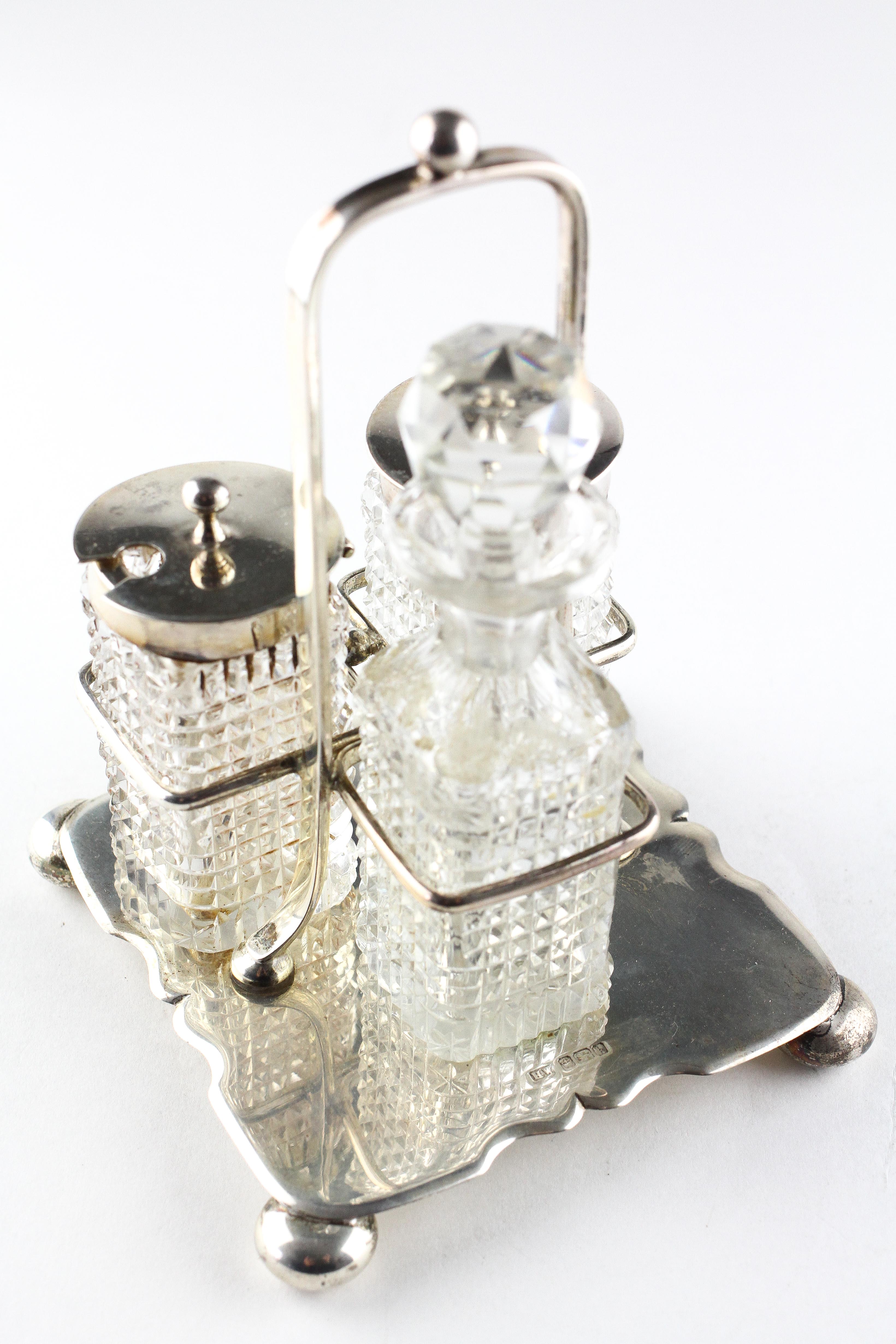 An Edwardian silver cruet on stand, comprising two silver topped glass pots and a glass bottle, - Image 2 of 3