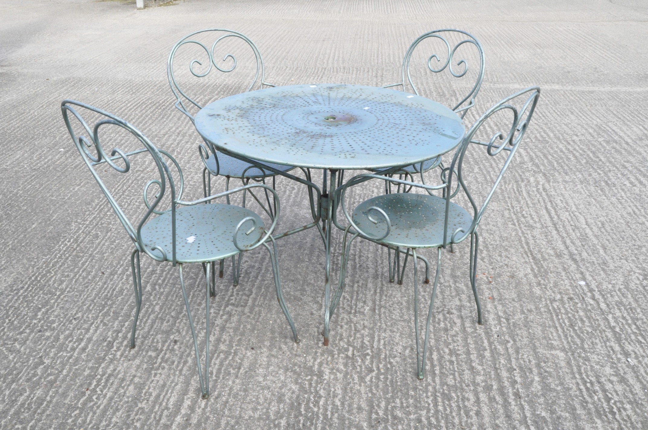A vintage French metal table and four chairs, in metallic pale blue,