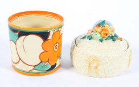 A Clarice Cliff jar (Wilkinson's Fantastique) and a Newport Pottery preserve pot and cover