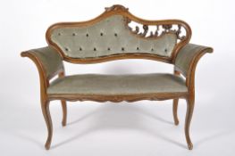 An Edwardian style mahogany window seat, with scrolling, pierced back and serpentine seat,