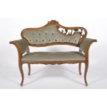 An Edwardian style mahogany window seat, with scrolling, pierced back and serpentine seat,