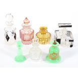 A collection of vintage scent bottles, including Art Deco examples in black and frosted glass,