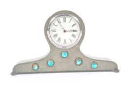 A Liberty Tudric pewter mantel clock case, with turquoise enamelled jewels, 12cm high,