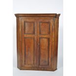 A French 19th century corner cupboard, with two reeded double doors enclosing three shelves,