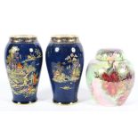 A pair of Crown Devon blue-ground baluster vases and a Maling ginger jar and cover, circa 1920,