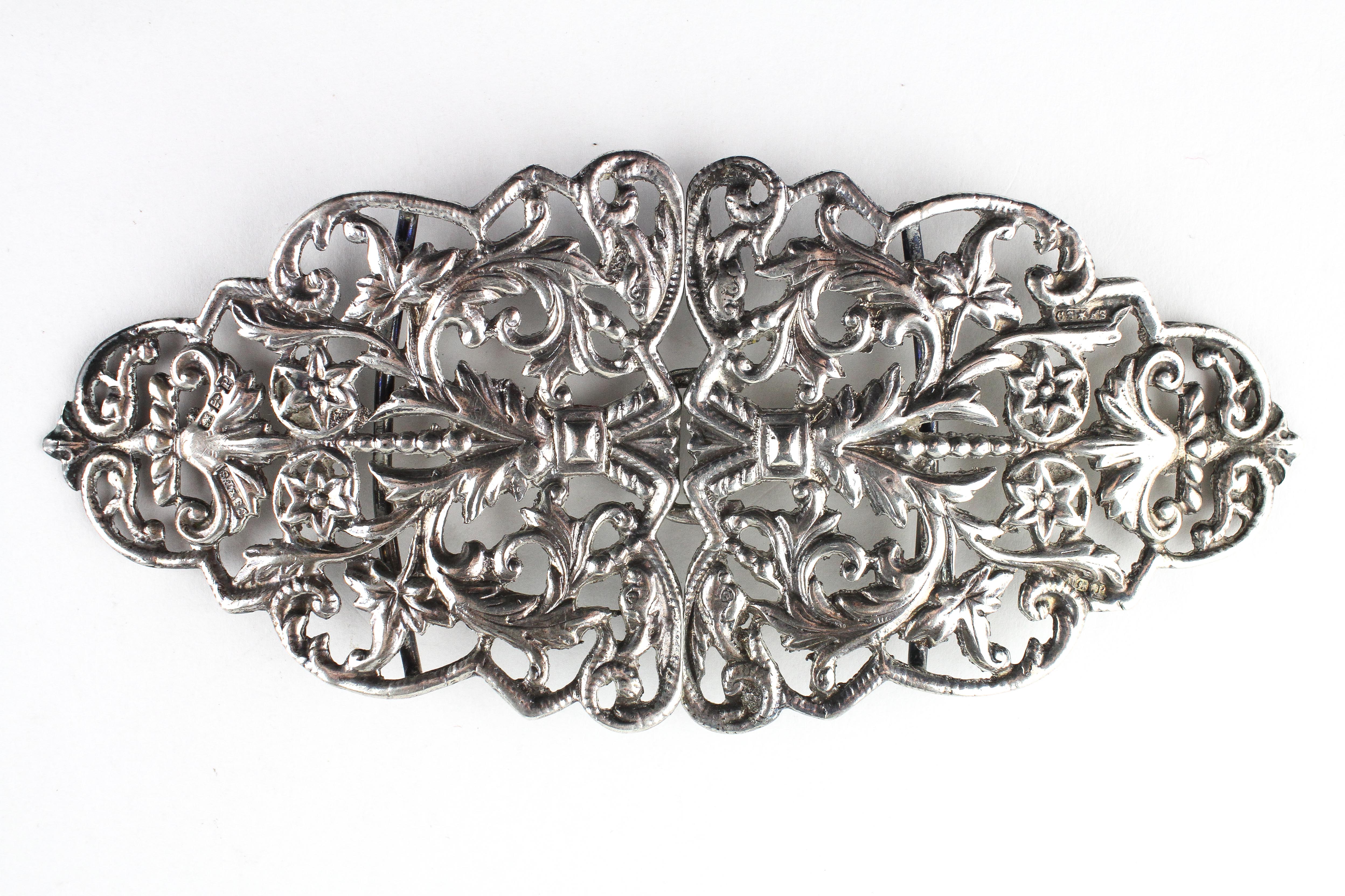 A large late Victorian silver buckle decorated with cast and pierced leaf and flower head design,