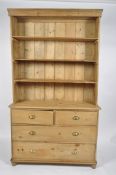 A Victorian pine dresser, the three shelf rack on a base with two short and two long drawers,