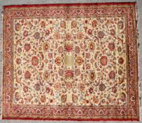 A 20th century wool Persian style rug, with scrolling leaves and flowers,