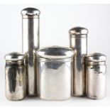 An Edwardian five piece silver set of travelling toiletries containers by Asprey & Co,