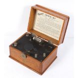 An Ericsson crystal set, with sweep tuning dial and detector, in hinged oak case,