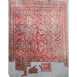 An Ushak Carpet, the tomato red field with columns of medallions,