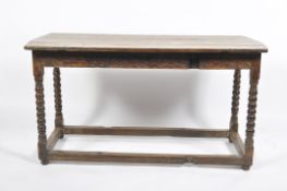 An oak table, 18th century and later, the planked top bobbin turned legs and block stretchers,