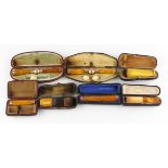 A collection of seven early 20th century amber pipes, including: four gold-mounted examples,