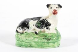 A Staffordshire pottery spongeware model of a cow, 19th century,