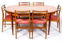 A mid-century G-Plan style dining table and six chairs, with pink upholstery,