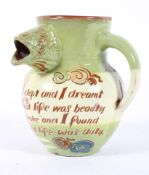 A dated Charles Brannam Barum slip-decorated jug, incised with leaping fish and a verse,