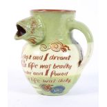 A dated Charles Brannam Barum slip-decorated jug, incised with leaping fish and a verse,