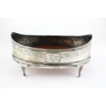 A small George III silver bread basket, of oval form, on four scroll legs,