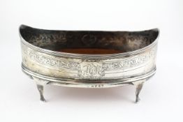 A small George III silver bread basket, of oval form, on four scroll legs,