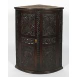 A Victorian carved oak corner cabinet, late 18th century,