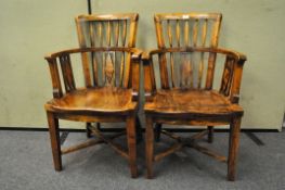 A pair of hardwood armchairs,