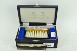 A Mappin and Webb silver mounted dressing table brush and comb set, in original fitted box,