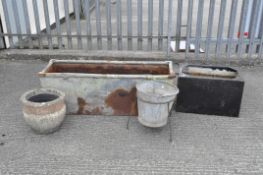 Three troughs, a stone planter and another,