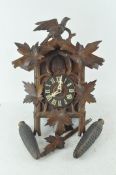 A Swiss or Black Forest style cuckoo clock with pendulum and weights,