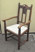 An early 20th century Arts and Crafts style elbow chair,