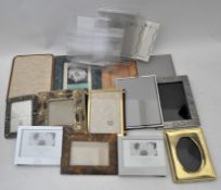 Assorted picture frames along with a selection of plastic picture frames