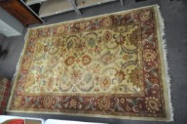 An Indian rug, with scrolling foliage on a beige ground,