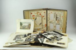 A Victorian photograph album with a large collection of loose vintage photos