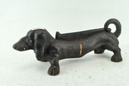 A heavy cast iron shoe scraper, in the form of a dachshund,