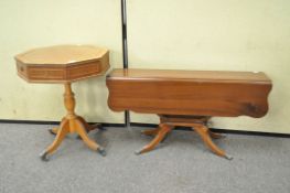 A reproduction drum style occasional table and another drop leaf table,