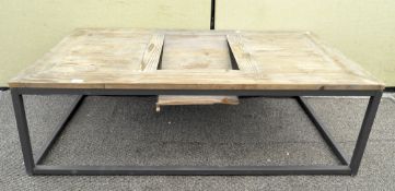 A modern plank top coffee table on tubular base,