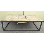 A modern plank top coffee table on tubular base,