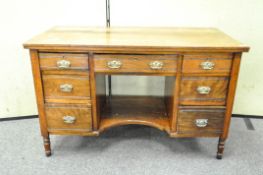 A Victorian mahogany desk with seven drawers around a kneehole,