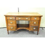 A Victorian mahogany desk with seven drawers around a kneehole,