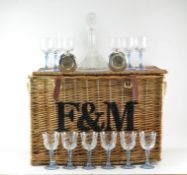 A Fortnum and Mason wicker basket, 42cm high x 64cm wide x 41cm deep; with 12 wine glasses,
