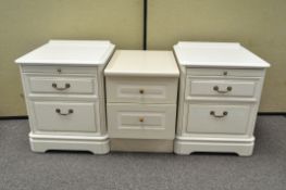 A pair of white bedside cabinets with two drawers and a slide,