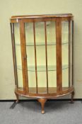 An Art Deco style display cabinet, of demi-lune form,