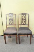 A pair of Regency style mahogany and inlaid dining chairs,