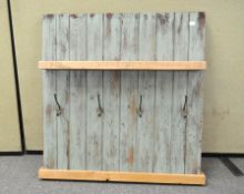 A shabby sheek coat rack with shelf, fashioned out of tongue and groove door,