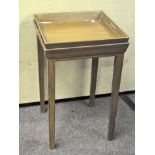 A contemporary square tray top table, raised on squared legs, 69cm x 44cm x 44cm.