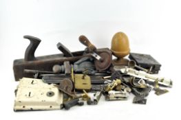 A collection of assorted items, including tools, a box plane,