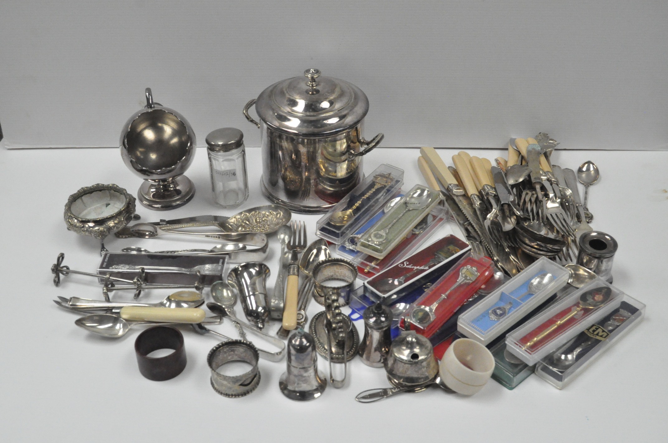 A collection of silver plated wares, including: casters, a biscuit barrel and cover, tongs, cutlery,